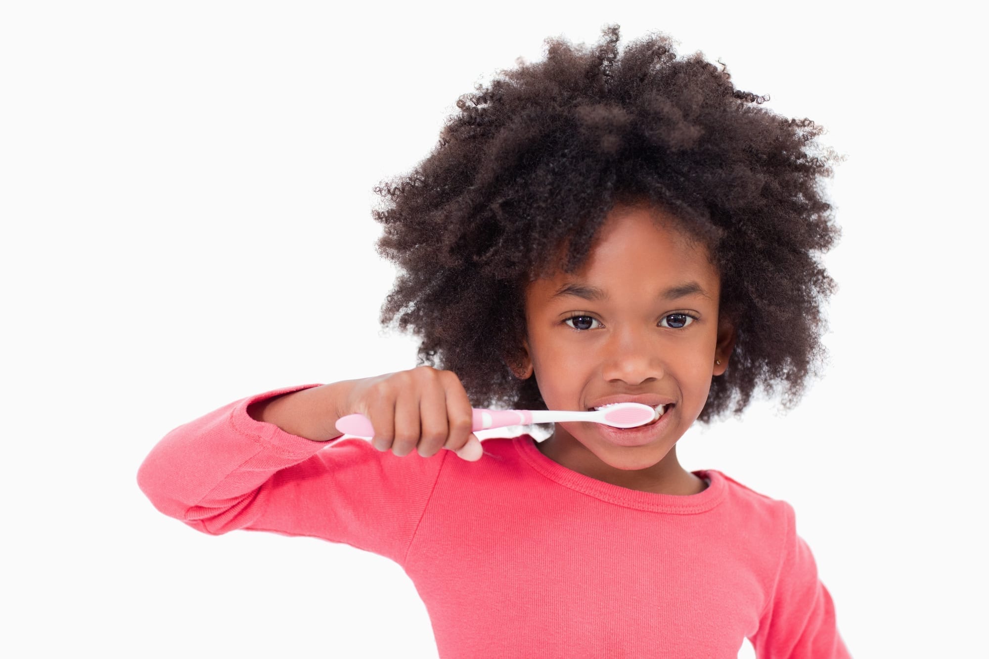 little girl brushing teeth on white background