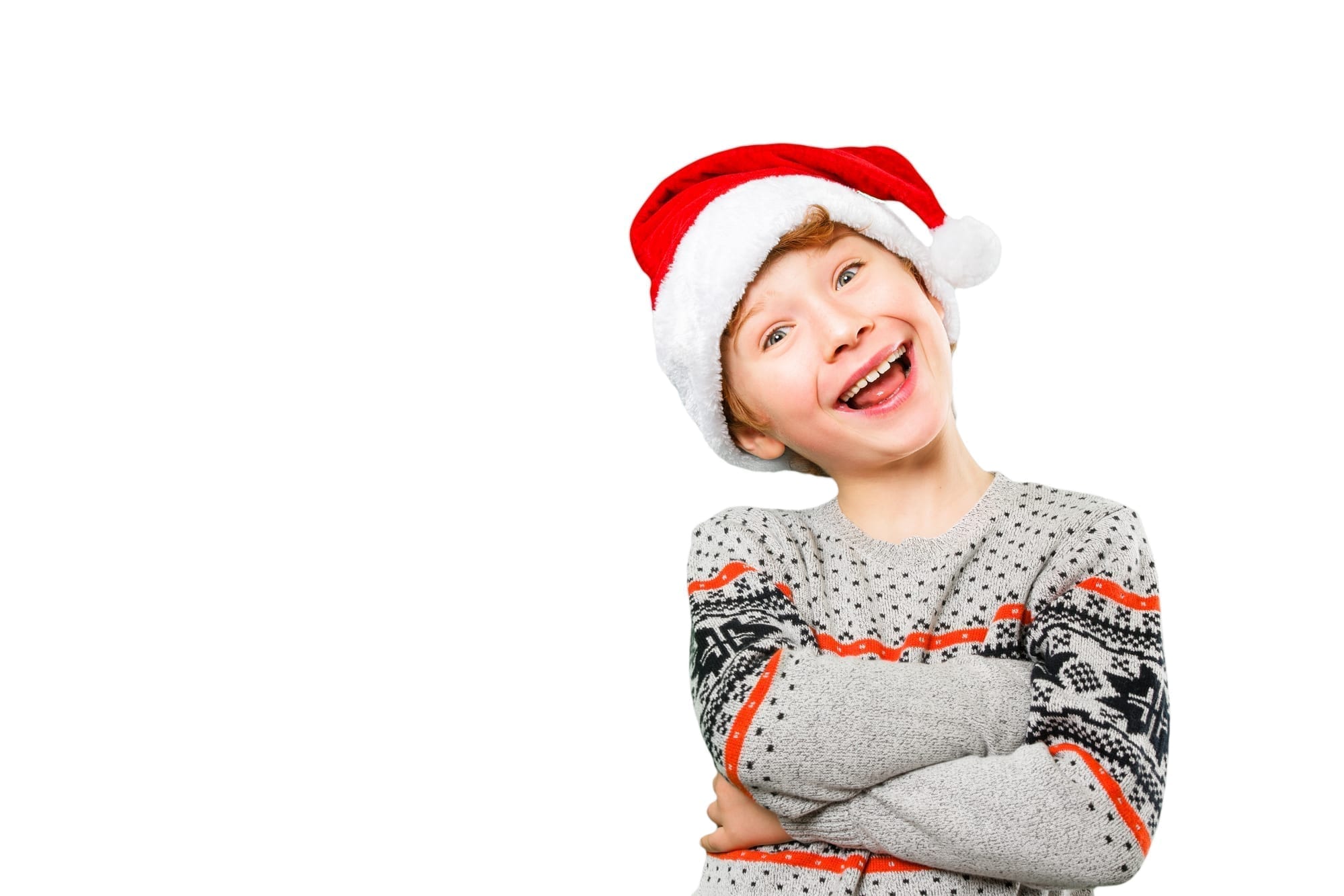 boy in santa hat smiling with arms crossed