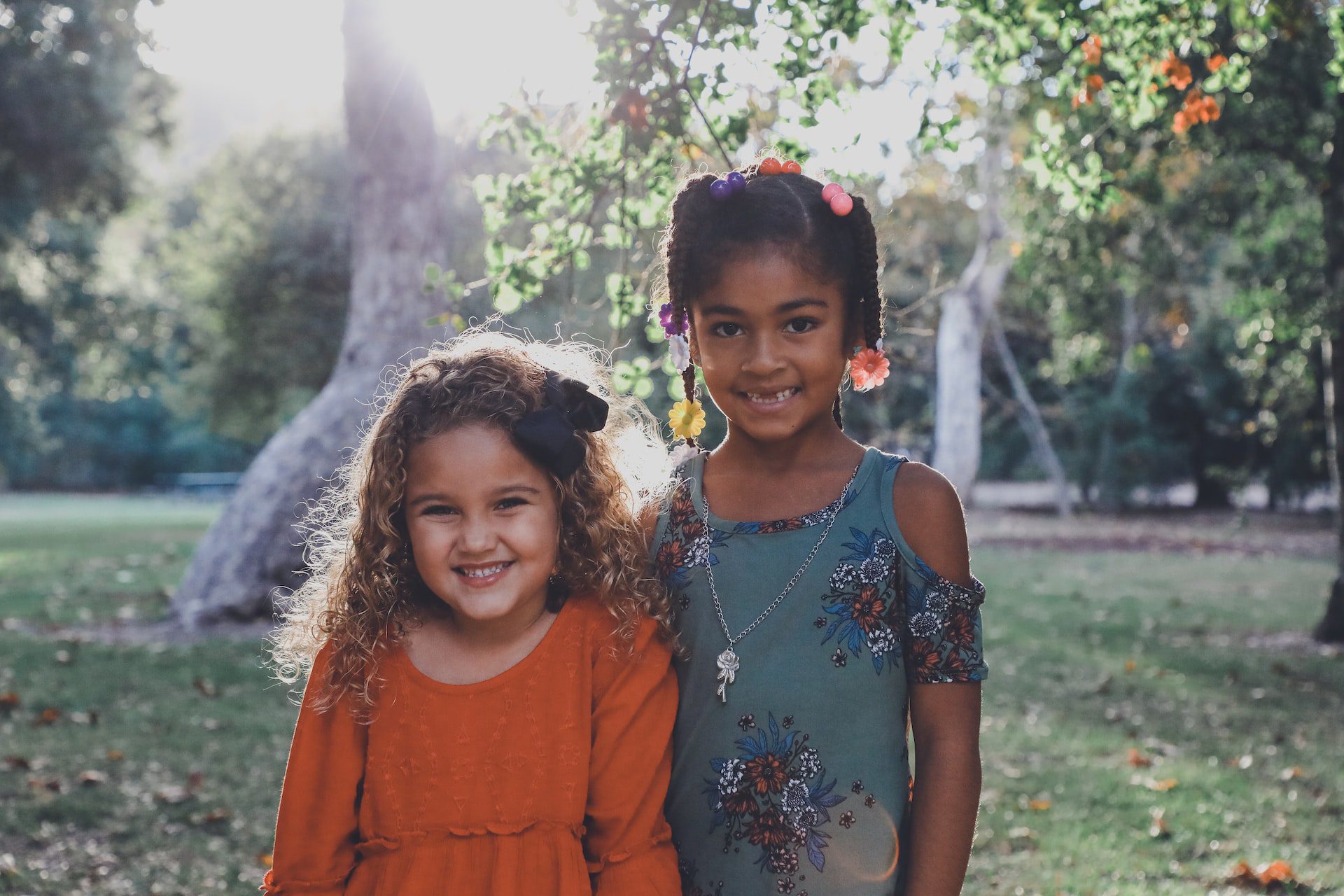 Two little girls smile after brushing up for National Children’s Dental Health Month in Overland Park, KS