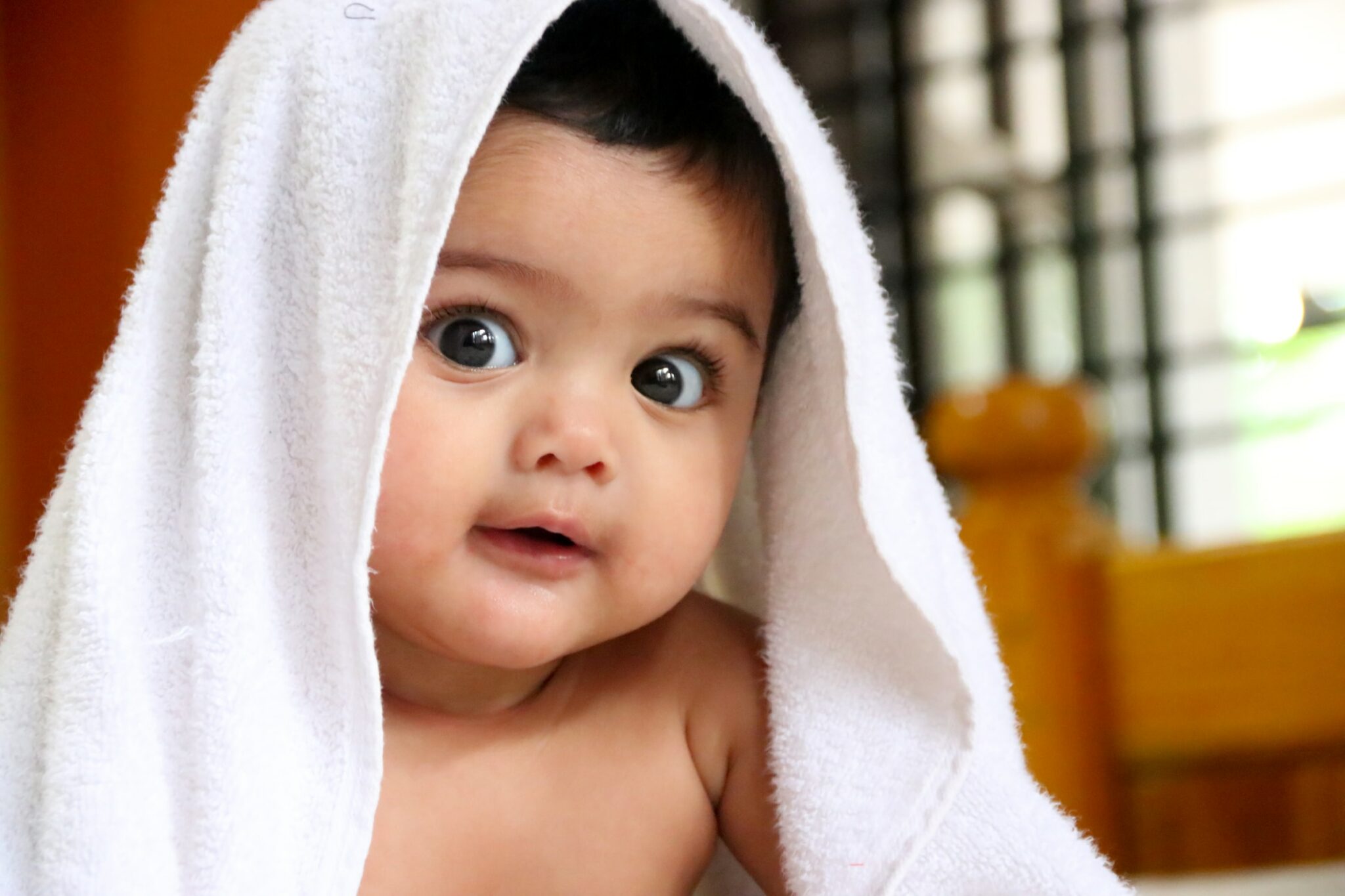 baby with white towel on his head